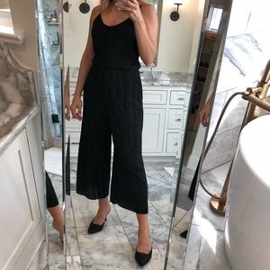 Black Plissé romper size S (4-6)